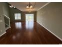 Spacious living room with hardwood floors, high ceilings, and a sliding door to the outdoor space at 256 Connemara Dr. # 13-C, Myrtle Beach, SC 29579