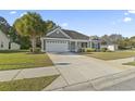 Attractive home featuring a long driveway and palm tree accenting the well-manicured lawn at 2715 Wood Creek Ln., Conway, SC 29527