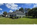 Well-maintained home with lush landscaping and large lawn at 2715 Wood Creek Ln., Conway, SC 29527