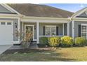 Inviting front entrance with decorative shrubs and a charming covered porch at 2715 Wood Creek Ln., Conway, SC 29527