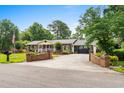 Long driveway leading to a two-car garage, framed by decorative brick walls and lush landscaping at 280 Morgan Ave., Little River, SC 29566