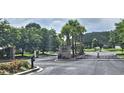 Gated community entrance offering security and privacy with mature trees in the background at 309 Outboard Dr., Murrells Inlet, SC 29576