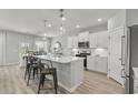 Bright kitchen features modern white cabinets, stainless appliances, a center island and an adjacent dining area at 315 River Edge Dr., Myrtle Beach, SC 29588