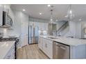 Modern kitchen with stainless appliances, white cabinets, a center island with a sink and white countertops at 315 River Edge Dr., Myrtle Beach, SC 29588