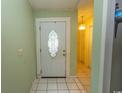 Inviting entryway featuring tiled flooring, a decorative front door and neutral wall paint at 318 Muirfield Rd., Myrtle Beach, SC 29588