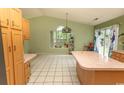 Spacious kitchen featuring a large island, tile floors, and ample natural light from the backyard view at 318 Muirfield Rd., Myrtle Beach, SC 29588