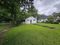 Quaint one-story home with a long stepping stone walkway and lush lawn and trees at 331 Dixon St., Mullins, SC 29574