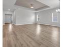 Bright living room with wood-look flooring, ample space, and modern ceiling fan at 346 High Falls Dr., Conway, SC 29526