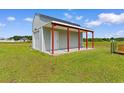 A versatile outbuilding offers additional storage and features a covered porch at 3617 Pasture Rd., Aynor, SC 29511