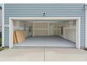 Spacious two-car garage with freshly painted walls and access door to the main house at 3657 Bells Lake Circle, Longs, SC 29568