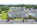 Aerial view of condo complex shows the surrounding community and lush green landscaping at 4142 Hibiscus Dr. # 102, Little River, SC 29566