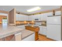 Bright kitchen features white cabinets, stainless steel appliances, and a movable island at 4366 Rivergate Ln. # 306, Little River, SC 29566