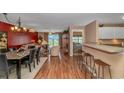 Open floor plan with kitchen bar, living area with sliding glass doors, and bedroom entrance at 4366 Rivergate Ln. # 306, Little River, SC 29566