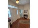 Inviting foyer featuring hardwood floors, elegant decor, and natural light at 448 Mahogany Dr. # 201, Murrells Inlet, SC 29576
