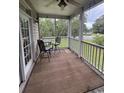 Relaxing screened-in porch featuring outdoor seating and views of the surrounding landscape at 448 Mahogany Dr. # 201, Murrells Inlet, SC 29576