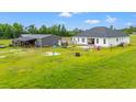 The backyard has a large grassy area for recreation, with outbuildings, a patio and play equipment at 4486 Bethel Rd., Aynor, SC 29511