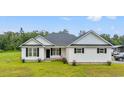 Charming home with white siding, black shutters, well-manicured lawn and inviting front entrance at 4486 Bethel Rd., Aynor, SC 29511