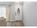 Bright entryway featuring a decorative door, light-colored walls and carpeted flooring at 462 Wallingford Circle, Myrtle Beach, SC 29588