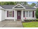 Inviting front of home featuring a decorative front door, columns, and tidy landscaping at 462 Wallingford Circle, Myrtle Beach, SC 29588
