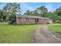 Classic brick home with a well-maintained lawn, showcasing its traditional charm and curb appeal at 475 Willard Rd., Conway, SC 29526