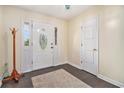 Bright foyer with an ornate front door, dark wood floors, and a coat rack, providing an elegant entrance at 475 Willard Rd., Conway, SC 29526