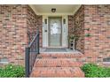 Inviting brick front porch with decorative plants and stylish black railing, offering a warm welcome at 475 Willard Rd., Conway, SC 29526