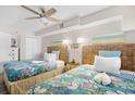 Bedroom featuring two beds with tropical themed bedspreads at 4800 S Ocean Blvd. # 514, North Myrtle Beach, SC 29582