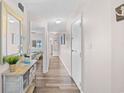 Hallway with wood floors and view to other room with a bed at 4800 S Ocean Blvd. # 514, North Myrtle Beach, SC 29582