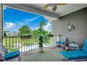 Cozy balcony with comfortable seating and scenic views of the pool and surrounding landscape at 4894 Luster Leaf Circle # 403, Myrtle Beach, SC 29577
