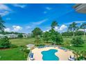 Relaxing community pool area surrounded by lush greenery and comfortable lounge chairs at 4894 Luster Leaf Circle # 403, Myrtle Beach, SC 29577