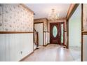Inviting entryway features a chandelier, wood trim, and stairs leading upstairs to other bedrooms at 4920 Meadow St., Loris, SC 29569