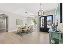 Bright dining room featuring modern chandelier, seating for eight, and stylish decor at 558 Oxbow Dr., Myrtle Beach, SC 29579