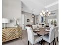 Dining room showcasing hardwood floors, modern chandelier, and seating for six at 558 Oxbow Dr., Myrtle Beach, SC 29579