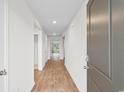 Bright hallway featuring sleek wood-look flooring and access to various rooms at 572 Woodland Farms Circle, Aynor, SC 29511