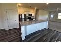 Well-equipped kitchen featuring granite countertops, stainless steel appliances, white cabinets and an island at 594 Castillo Dr., Loris, SC 29569