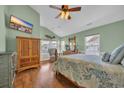 Bright bedroom featuring hardwood floors, vaulted ceiling, and a view of the outdoors at 6001 - Mh 17A South Kings Hwy., Myrtle Beach, SC 29575