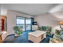 Inviting living room with comfy seating and sliding glass doors to a balcony with ocean views at 618 N Waccamaw Dr. # B7, Garden City Beach, SC 29576