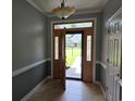 Elegant foyer with tile flooring and a decorative front door with sidelights at 6542 Wellington Dr., Murrells Inlet, SC 29576