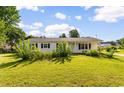 A well-maintained white house with a green lawn and beautiful landscaping is ready for move in at 704 Bonnie Dr., Myrtle Beach, SC 29588