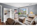Comfortable living room with modern decor, balcony access and view of the pool at 7700 Porcher Dr. # 3205, Myrtle Beach, SC 29572