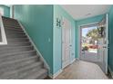 Bright entryway with turquoise walls, wood floors, and a view of the front yard through the glass-paneled front door at 798 Woodland Farms Circle, Aynor, SC 29511