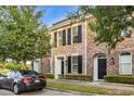 Brick townhomes with black shutters, manicured front lawns, and a parked car at 945 Rosencrans Ln. # B, Myrtle Beach, SC 29577