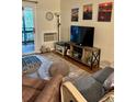 Comfortable living room with television, coastal-themed decor, and a view of the outdoor balcony at 9501 Shore Dr. # 323, Myrtle Beach, SC 29572