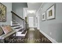 Staircase and Entryway featuring hardwood floors and trim, with neutral paint at 1004 Fowler Rd., Conway, SC 29526