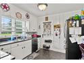 Well-lit kitchen with white cabinets, stainless steel appliances, a window overlooking the yard, and a convenient back door at 1008 N Withlacoochee Ave., Marion, SC 29571