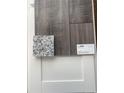 Interior design finishes featuring Shaw luxury vinyl plank flooring, white cabinets, and granite countertop at 1010 Black Locust Pl., Longs, SC 29568