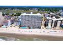 Aerial view of the resort on the beach with pools, lounge chairs, and stunning ocean views at 1012 N Waccamaw Dr. # 305, Garden City Beach, SC 29576