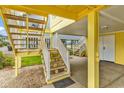 Ground level view showcases stairs leading to an elevated beach house at 121 Easy St., Garden City Beach, SC 29576