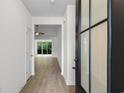 Bright foyer featuring a modern front door and an open view to the living area with hardwood floors at 124 Shady Arbor Loop, Longs, SC 29568