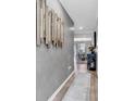 Stylish hallway featuring modern artwork, hardwood floors, and an open view into the dining area at 136 Crabapple Dr., Longs, SC 29568